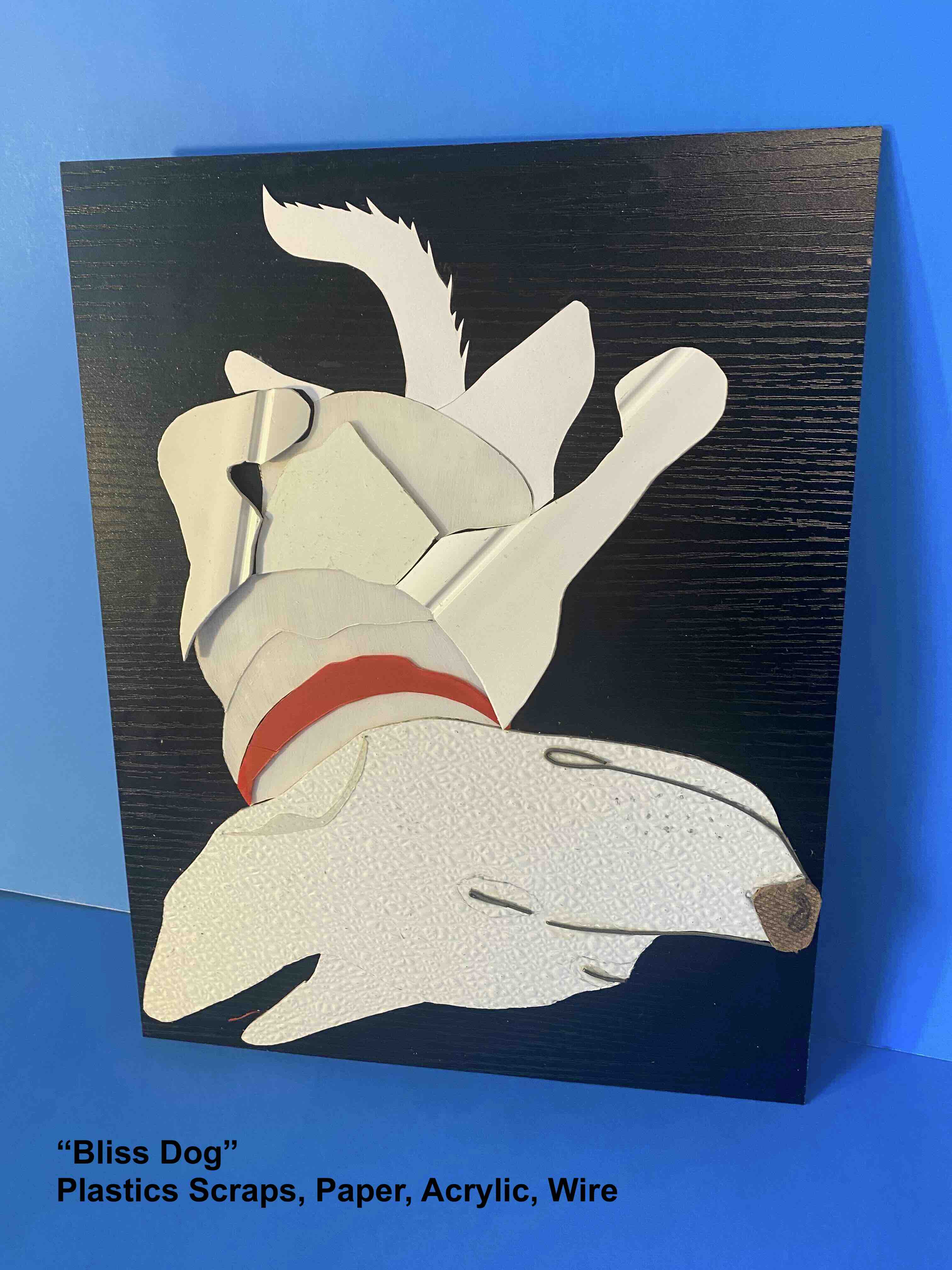 dog in blissful position made of plastic scraps